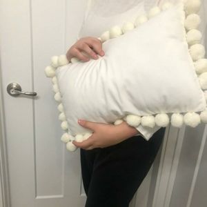White Throw Pillow with PomPom Detailing